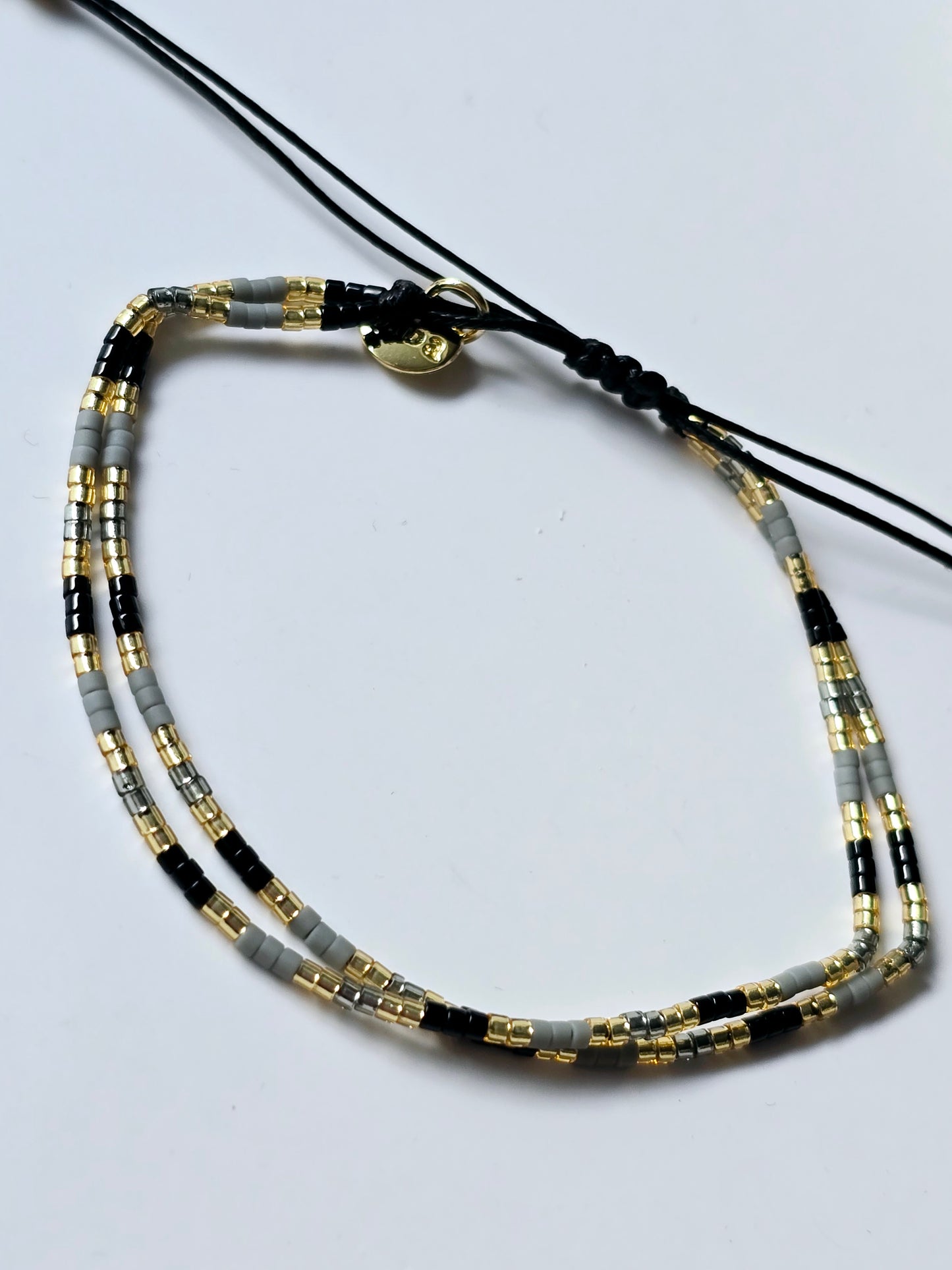 Armband schwarz/grau/gold